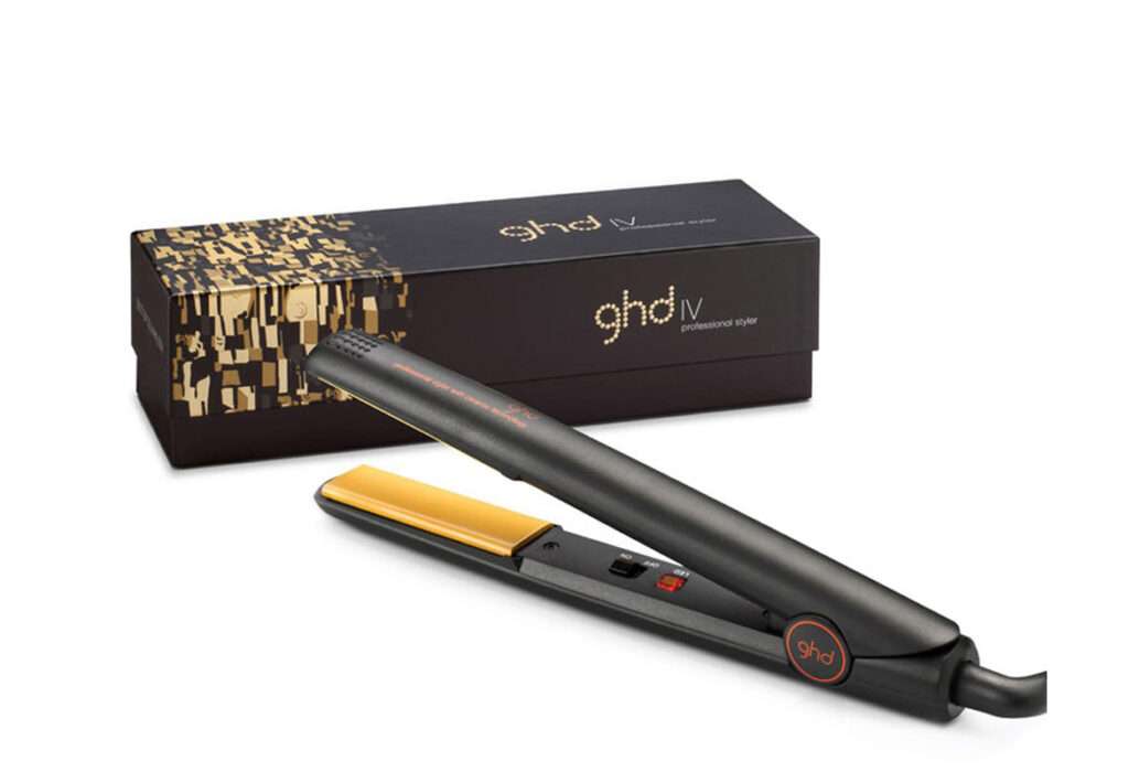 A black and gold hair straightener next to a box