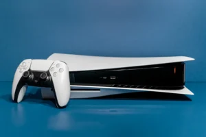 A white video game console sitting on top of a blue table